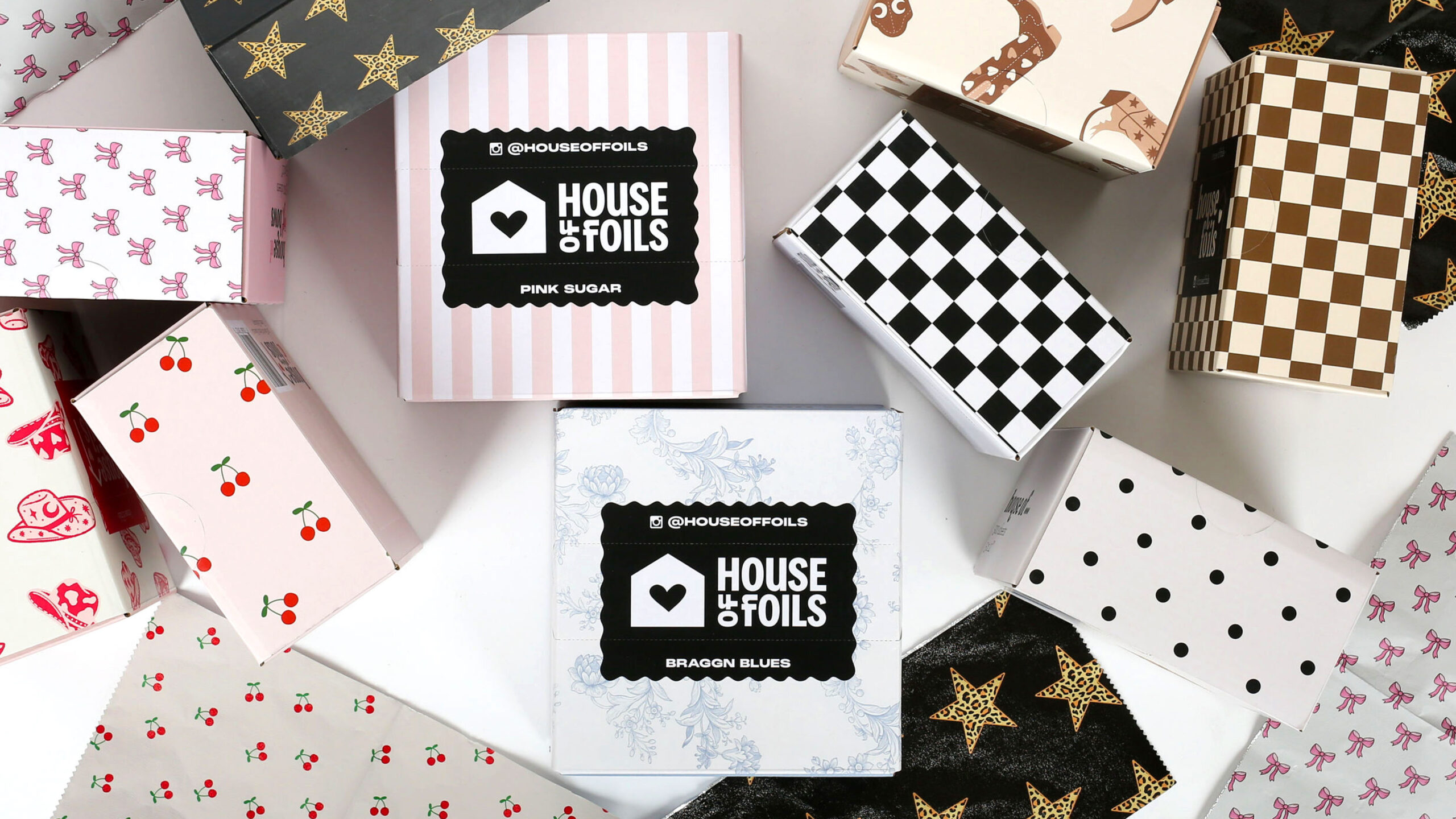 A collection of boxes with varied patterns of the different house of foils prints (for example stripes, checkers, etc.)