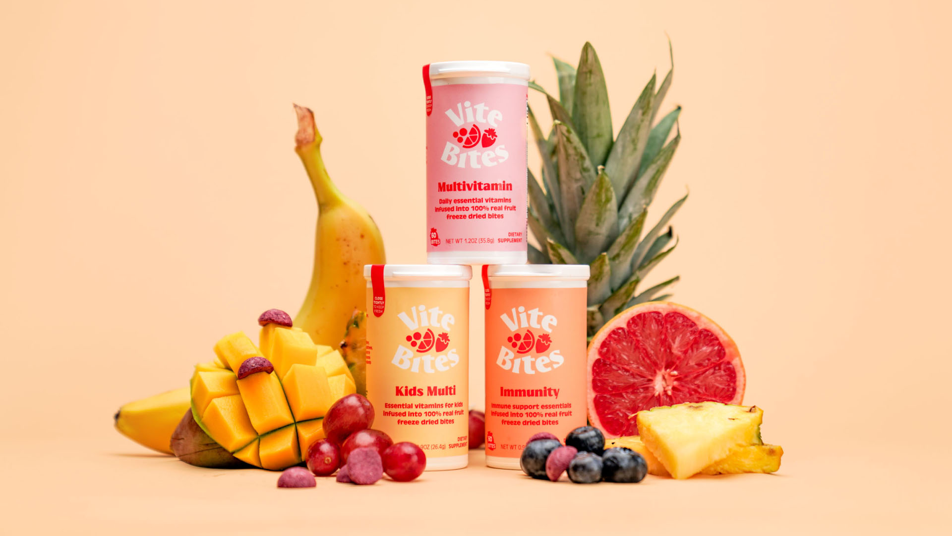 ViteBites Product Line ViteBites multivitamin, immunity, and kids supplements displayed with fresh fruit