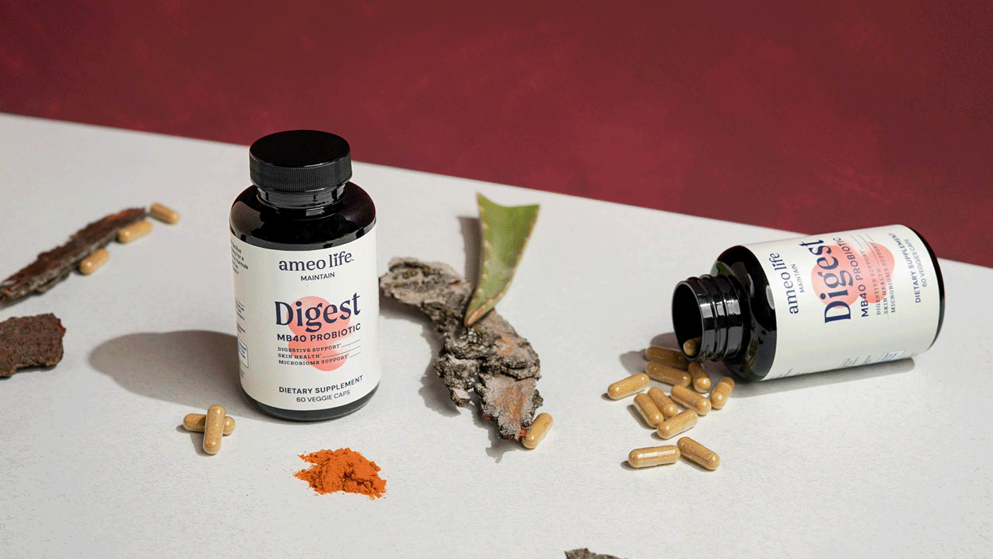 Ameo Life supplement still life photography Still life arrangement of Ameo Life supplement bottles with capsules and natural ingredients.