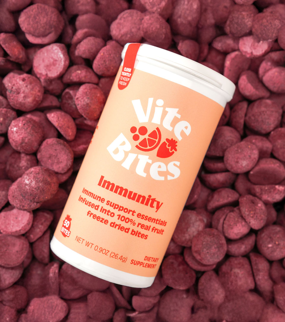 Vite Bites Product Close-Up Vite Bites immunity supplement container surrounded by freeze-dried fruit bites